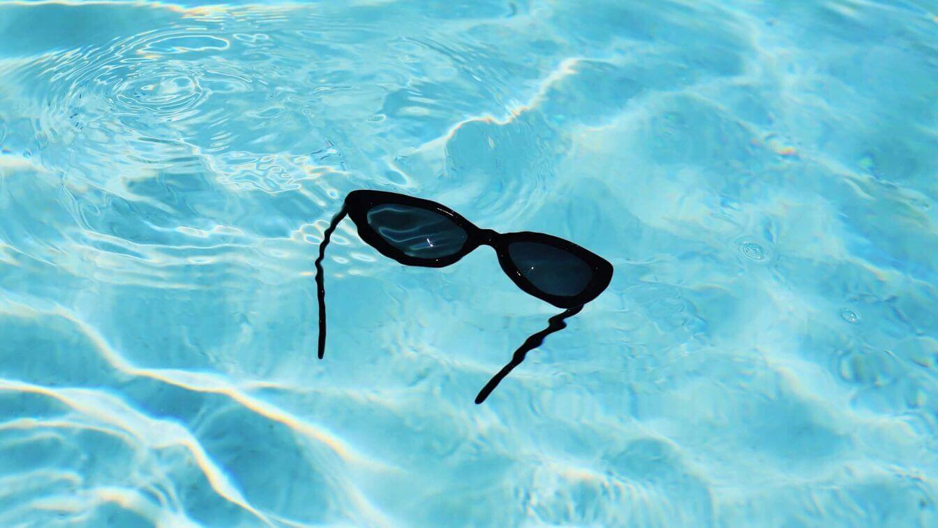 A pair of sunglasses in a swimming pool